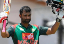 Tamim Iqbal celebrates his half-century with a smile during a cricket match.