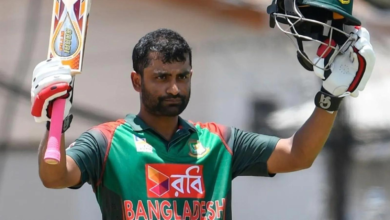 Tamim Iqbal celebrates his half-century with a smile during a cricket match.