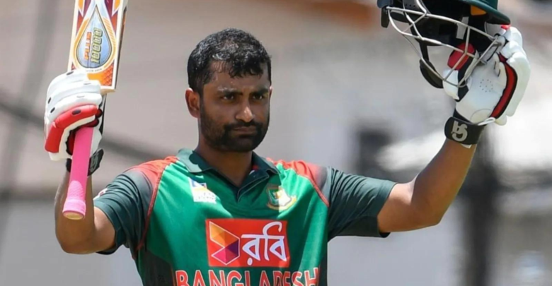 Tamim Iqbal celebrates his half-century with a smile during a cricket match.