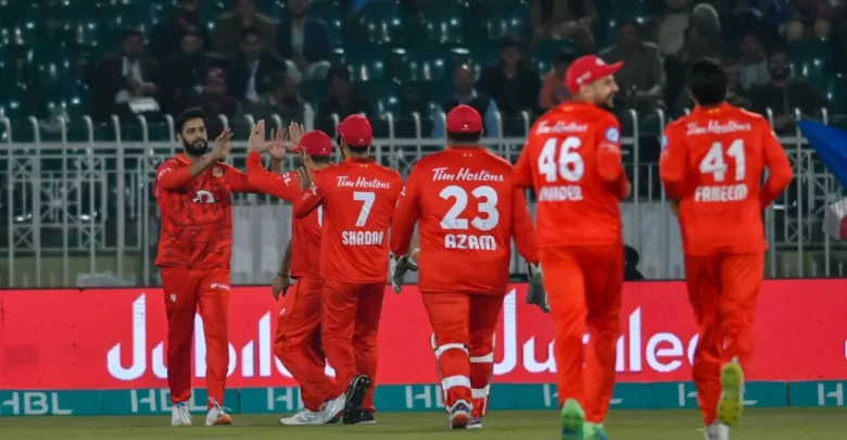 Islamabad United players celebrating after taking a wicket against Karachi Kings in a PSL 2024 match.