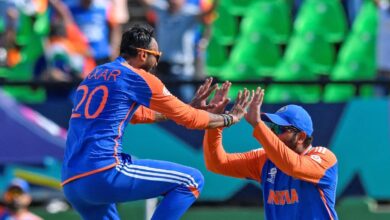 Axar Patel and Rohit Sharma celebrate taking a wicket during their T20 World Cup semi-final against England