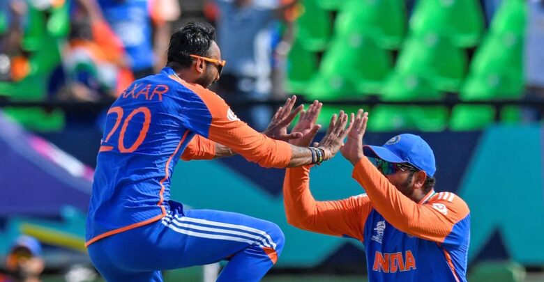 Axar Patel and Rohit Sharma celebrate taking a wicket during their T20 World Cup semi-final against England