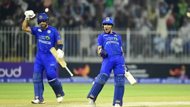 Rahmanullah Gurbaz raises his bat after scoring a century against South Africa in the second ODI.