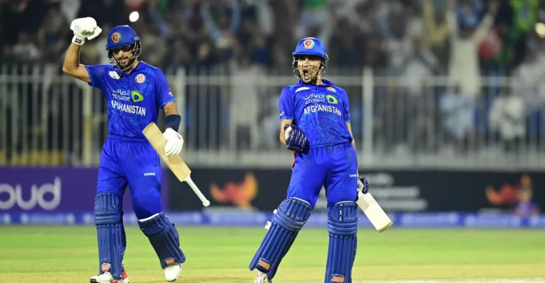 Rahmanullah Gurbaz raises his bat after scoring a century against South Africa in the second ODI.