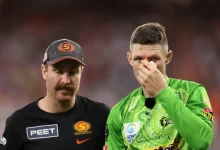 Cameron Bancroft sitting on the field receiving medical attention after a collision during the BBL match.