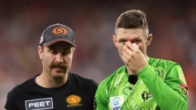 Cameron Bancroft sitting on the field receiving medical attention after a collision during the BBL match.